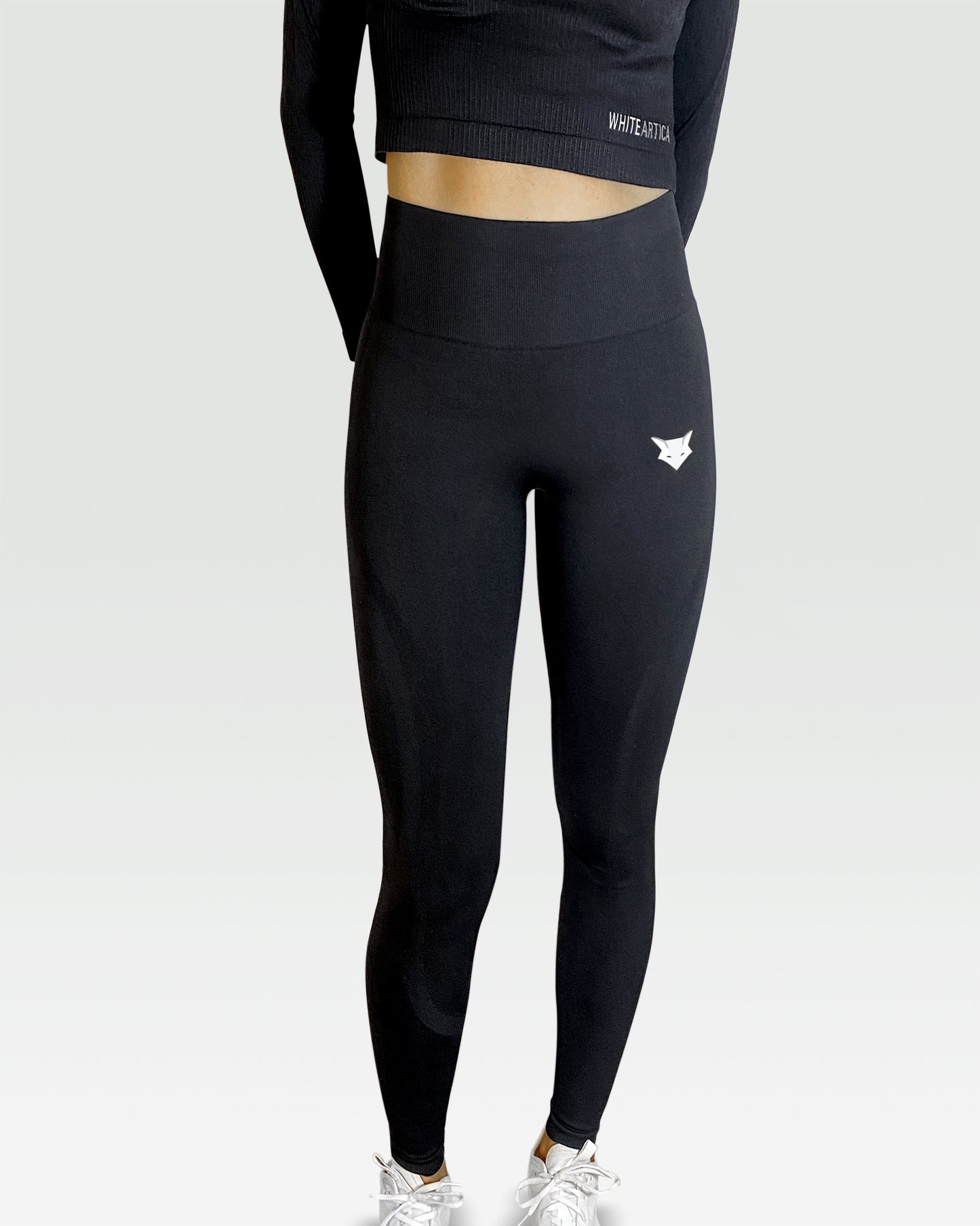 Australian woman wearing white artica high-waisted exercise pants and black leggings activewear to performance at her best during fitness workout using the best sports cloths and active wear