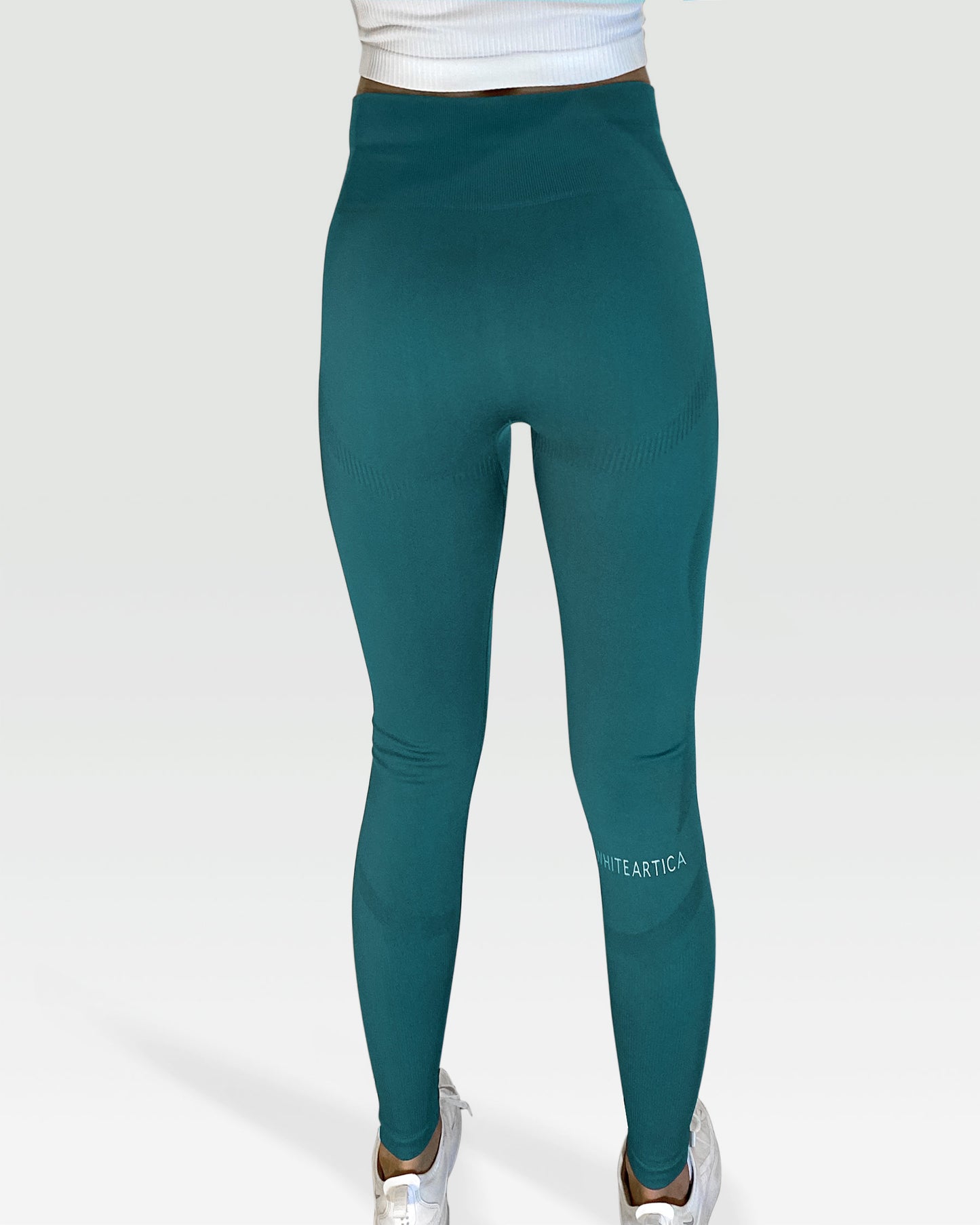 Australian woman wearing white artica high-waisted exercise pants and forrest sage leggings activewear to performance at her best during fitness workout using the best sports cloths and active wear