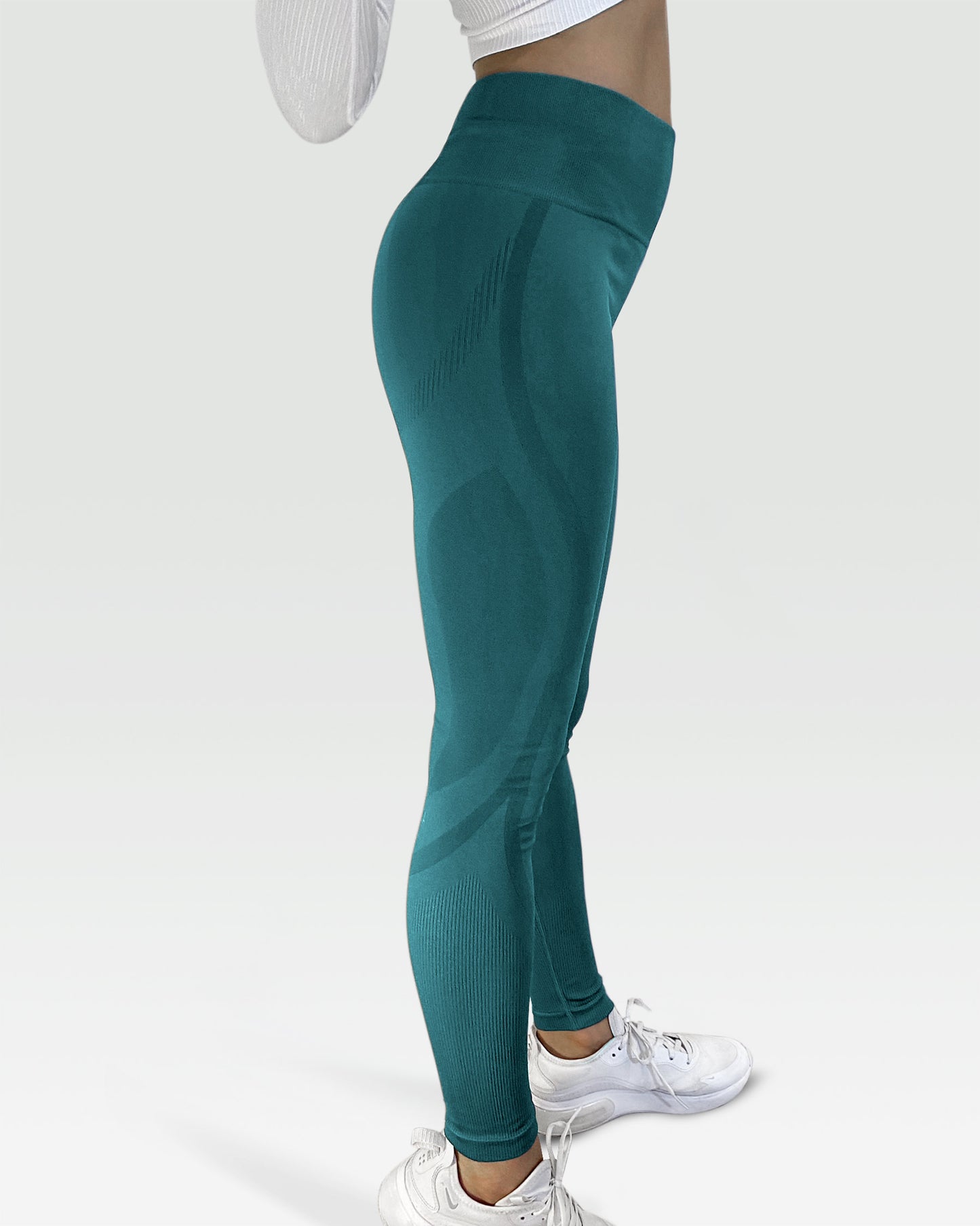 Australian woman wearing white artica high-waisted exercise pants and forrest sage leggings activewear to performance at her best during fitness workout using the best sports cloths and active wear