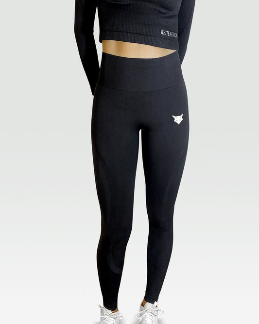 Australian woman wearing white artica high-waisted exercise pants and black leggings activewear to performance at her best during fitness workout using the best sports cloths and active wear